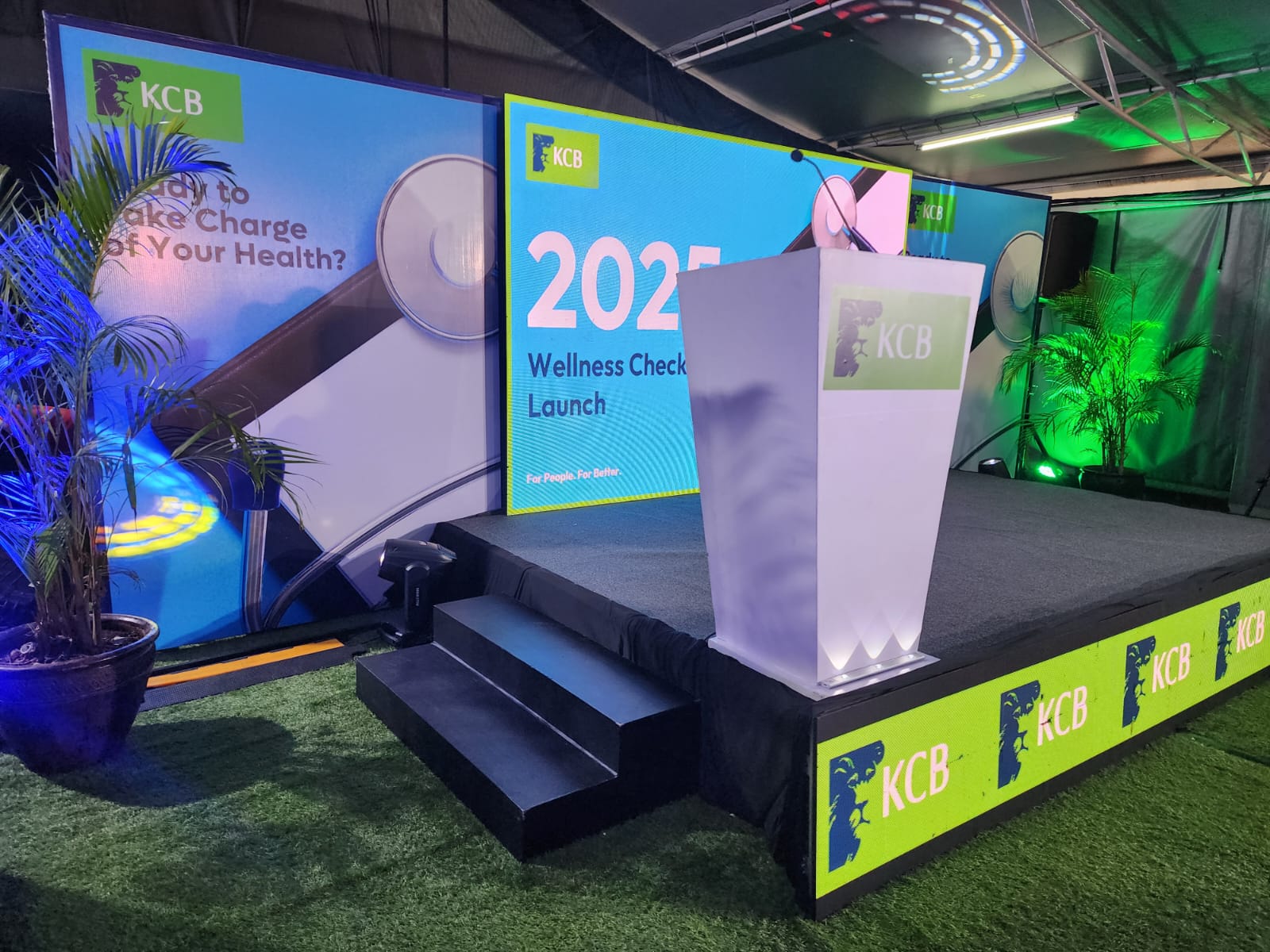 KCB 2025 Wellness Check Launch outdoor stage with LED screens, branded podium and green lighting, built by Progigs Audio Visual