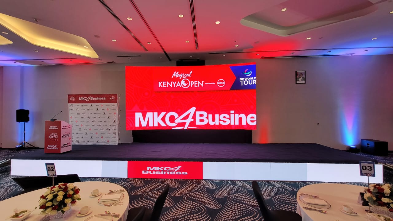 MKO4Business stage at the Magical Kenya Open with red LED screen and branded podium in Nairobi