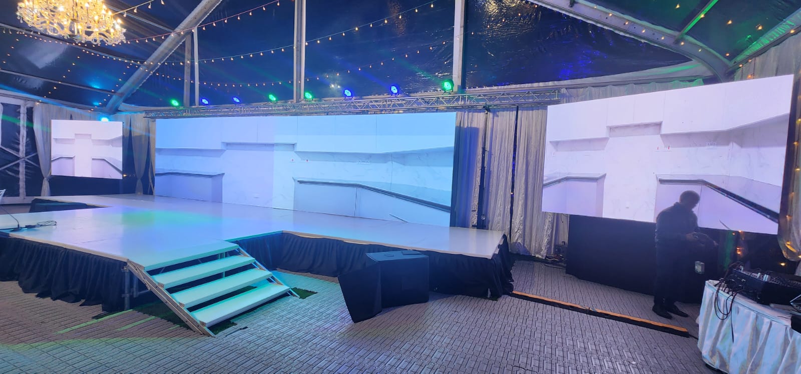 Marquee tent event with twin LED screens, white stage deck and festoon lighting in Nairobi