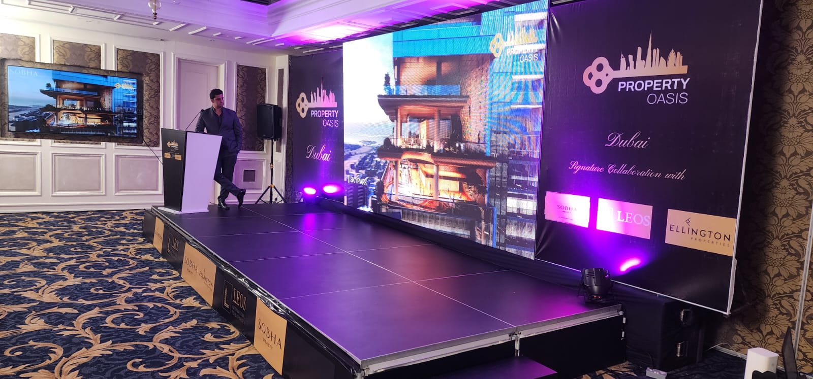 Property Oasis Dubai property launch with speaker at branded podium and LED wall