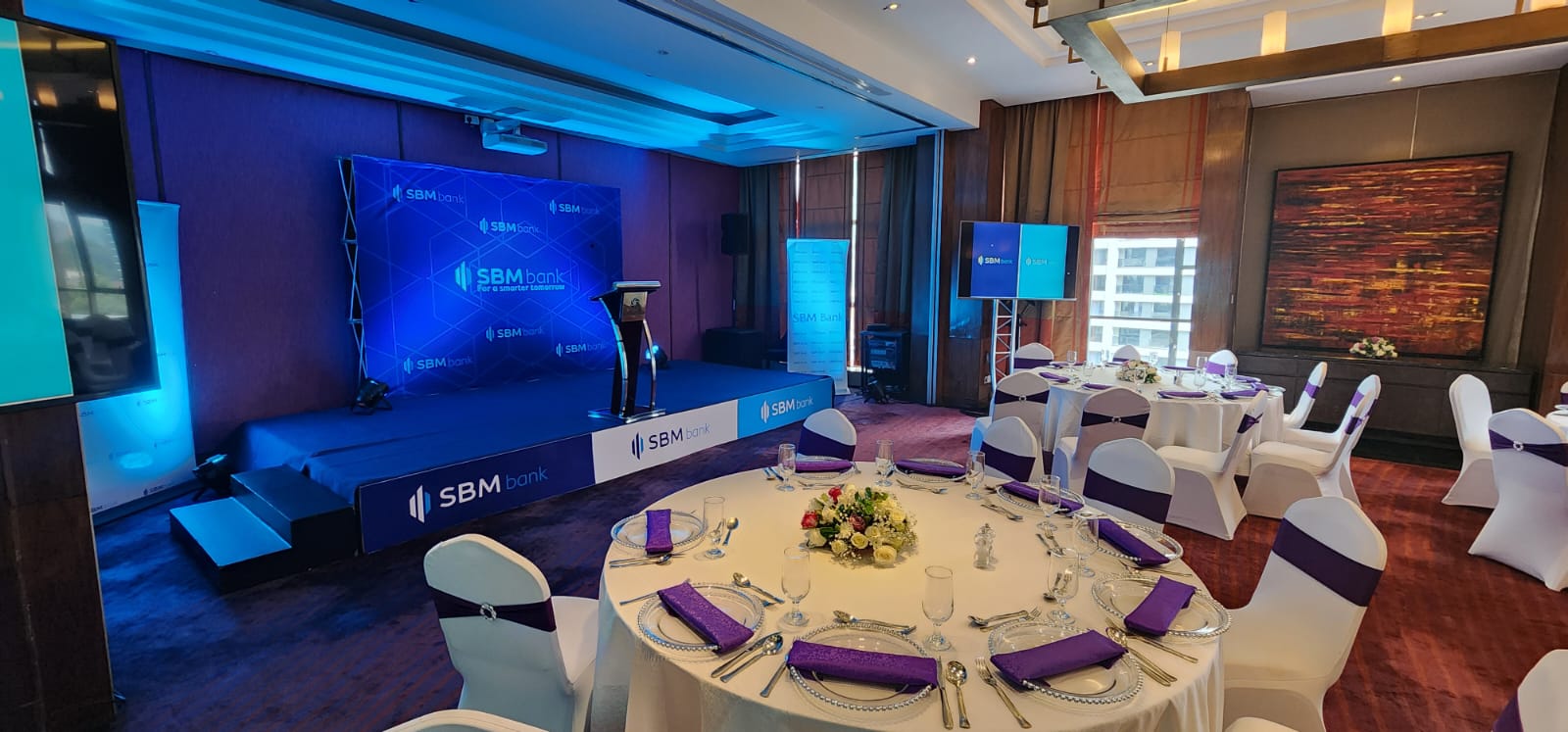 SBM Bank branded stage backdrop and banquet table setting at a Nairobi hotel