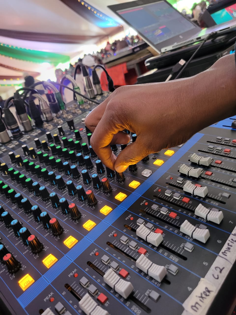Progigs Audio Visual sound engineer operating a live audio mixing console at an event in Nairobi